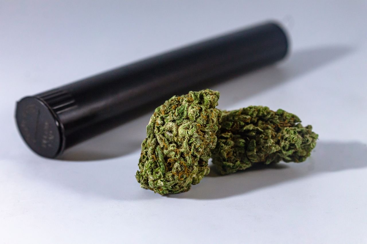 Mastering the First Impression: Your intriguing post title goes here Close-up of marijuana buds with a black storage container, ideal for medical or recreational use.